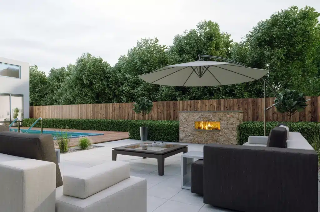 A patio with an outdoor fireplace and furniture.