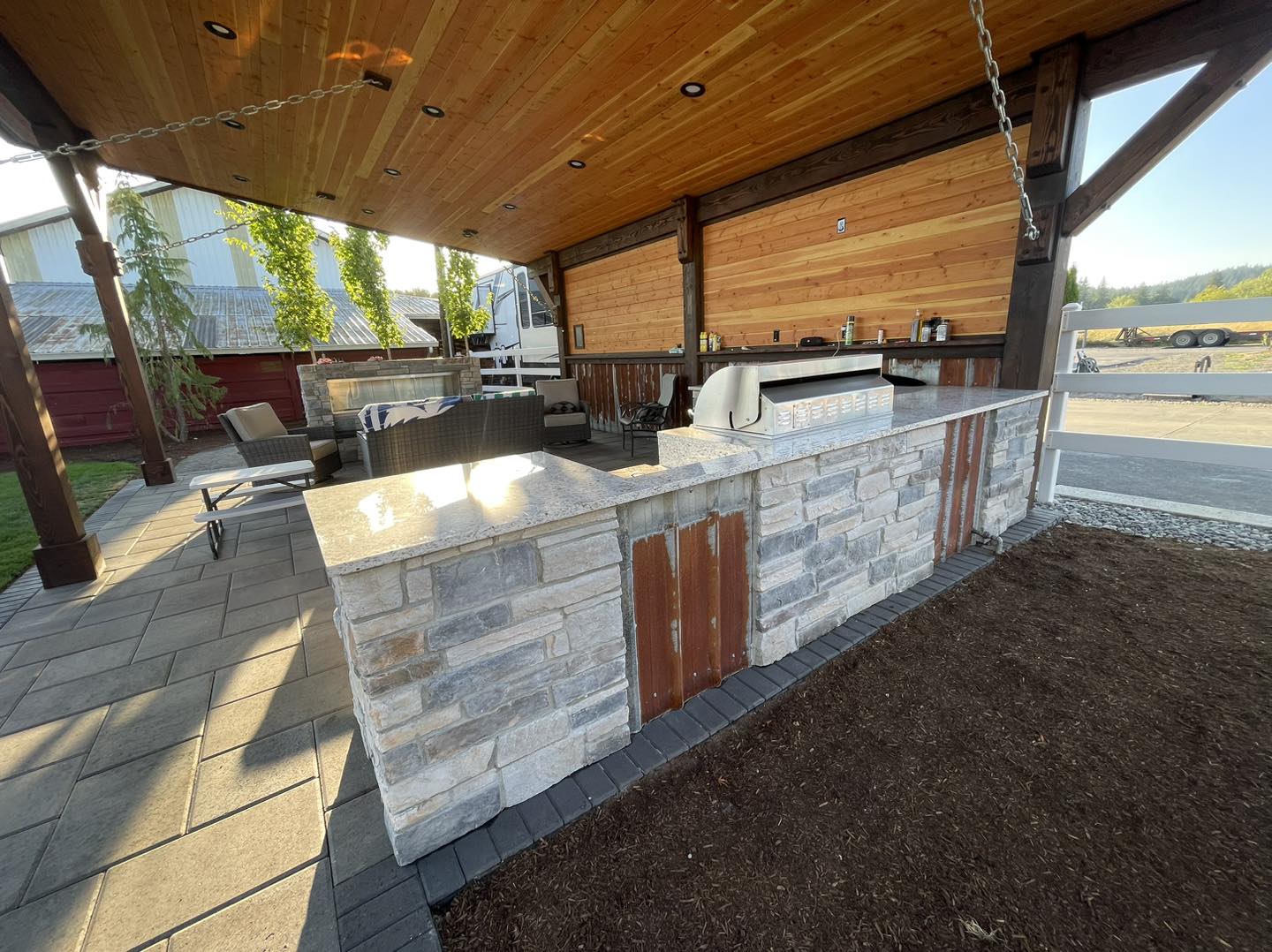 A large outdoor kitchen with an oven and grill.