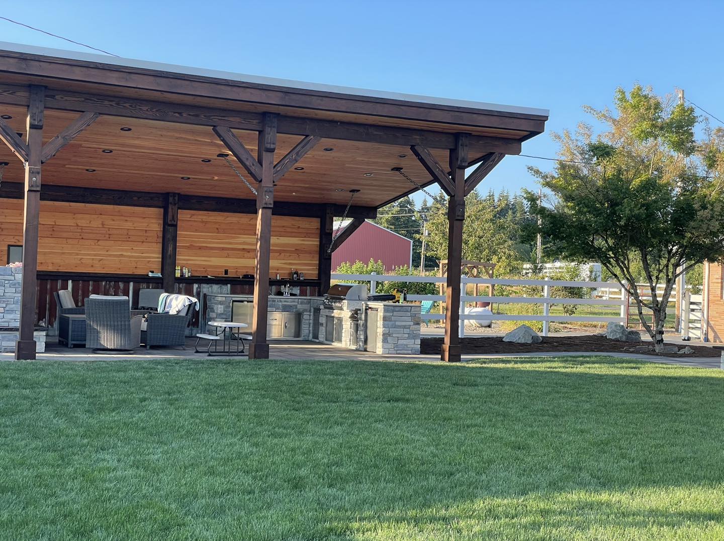 A large wooden structure in the middle of a park.