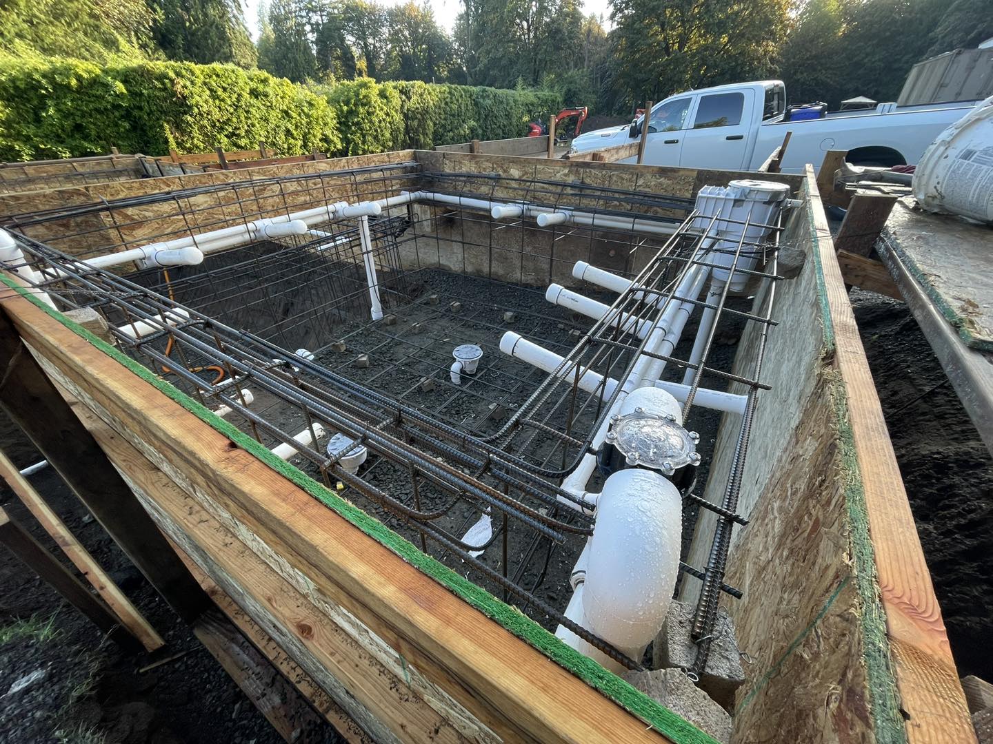 A construction site with concrete and pipes.