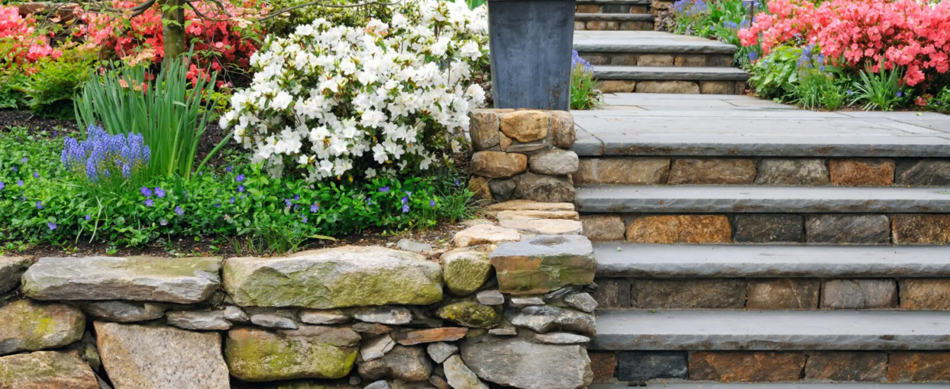 A stone wall with steps leading to the top of it.