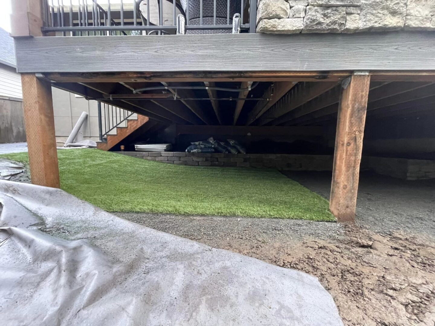 A green carpet under the roof of a house.