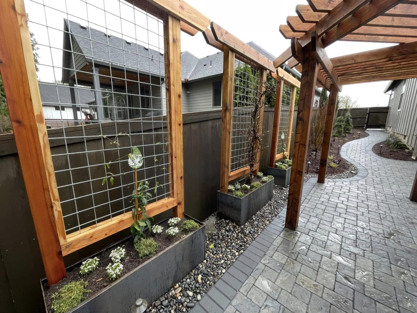 A walkway with wooden posts and trellis