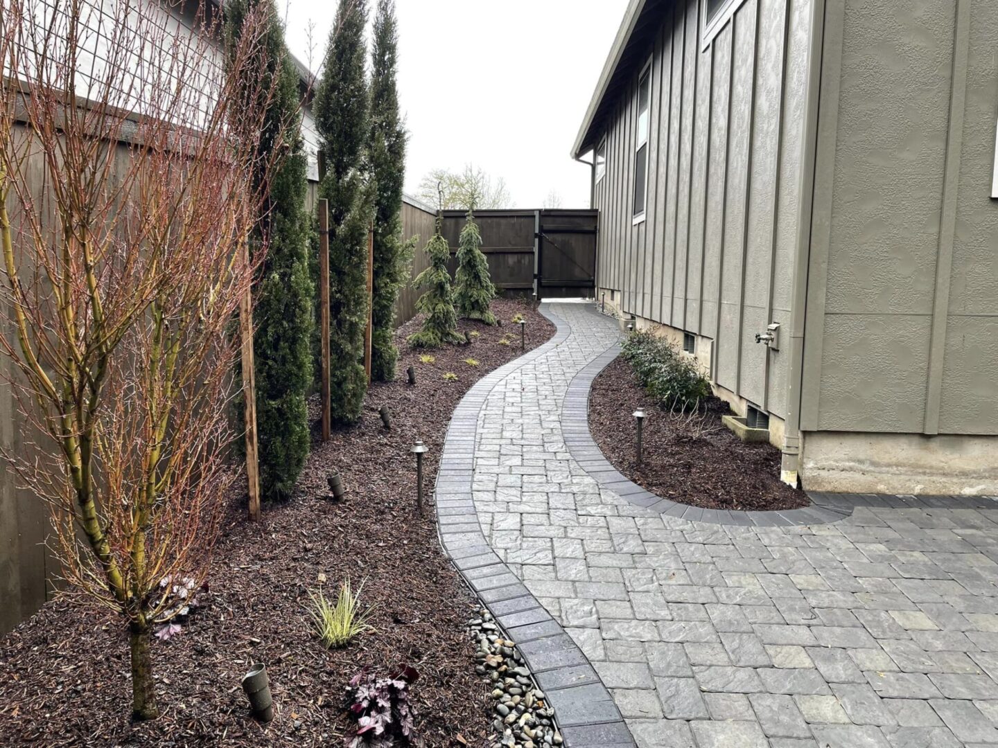 A walkway with brick and stone is shown.