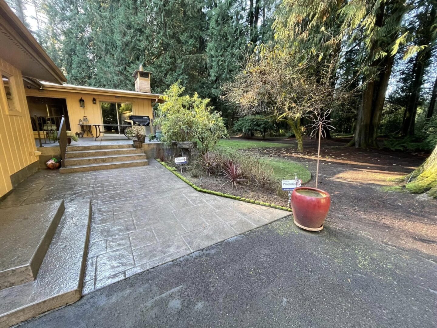 A large backyard with steps leading to the patio.