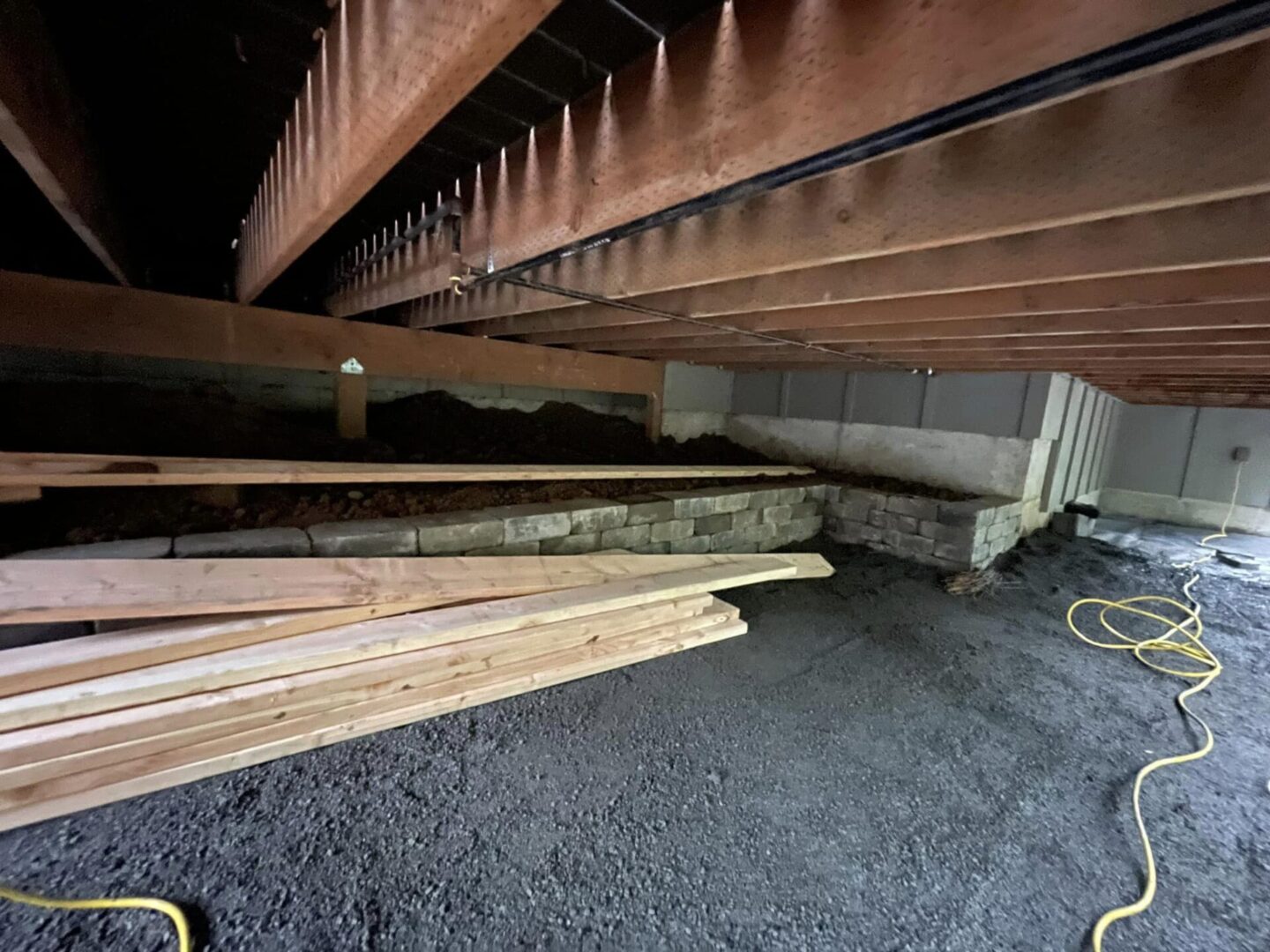 A pile of wood under a house.