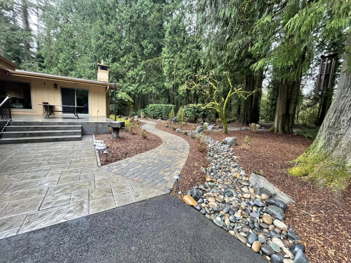 A walkway with a stone path and rocks in the middle of it.