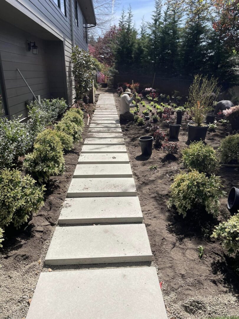 A walkway with steps leading to the side of a house.