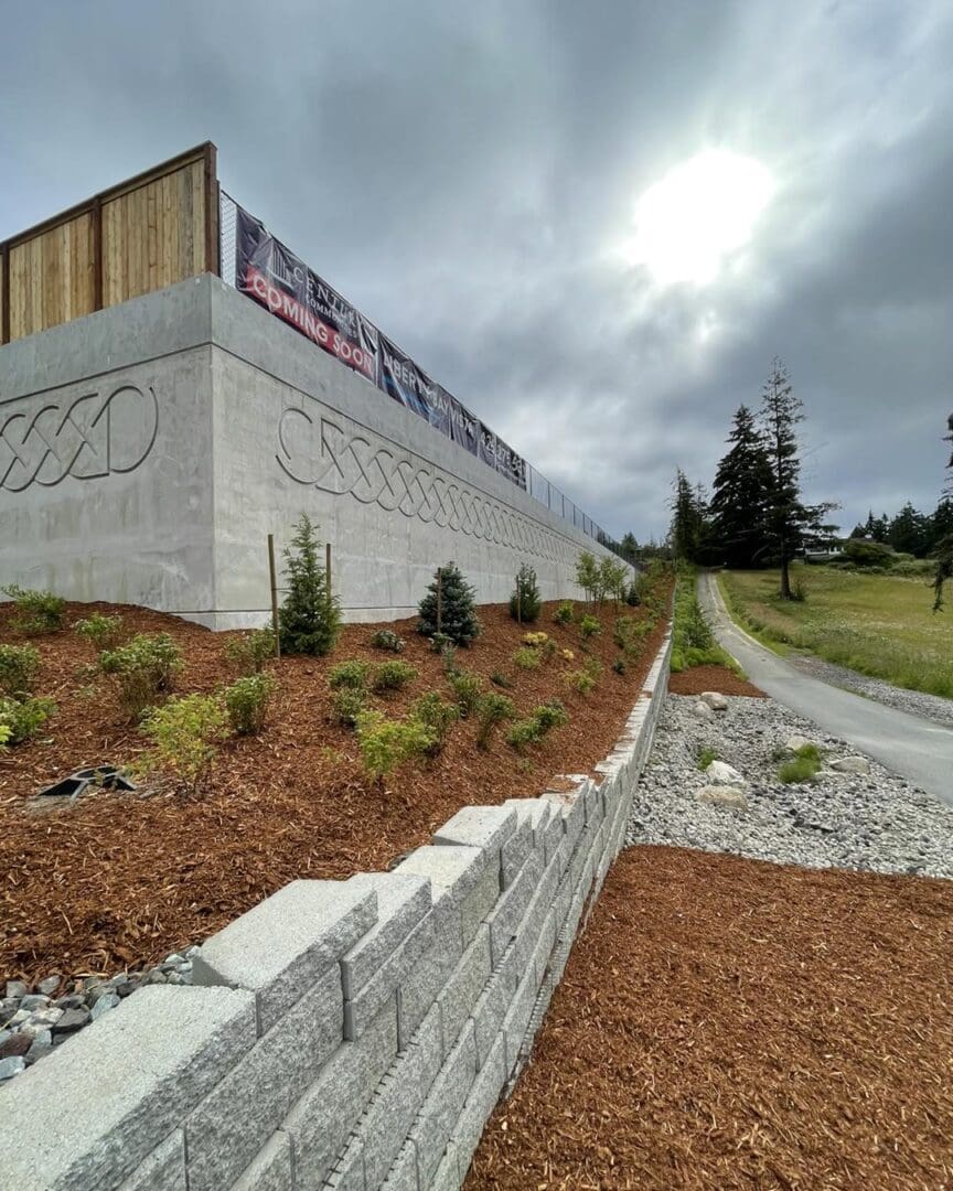 A concrete wall with a large olympic logo on it.