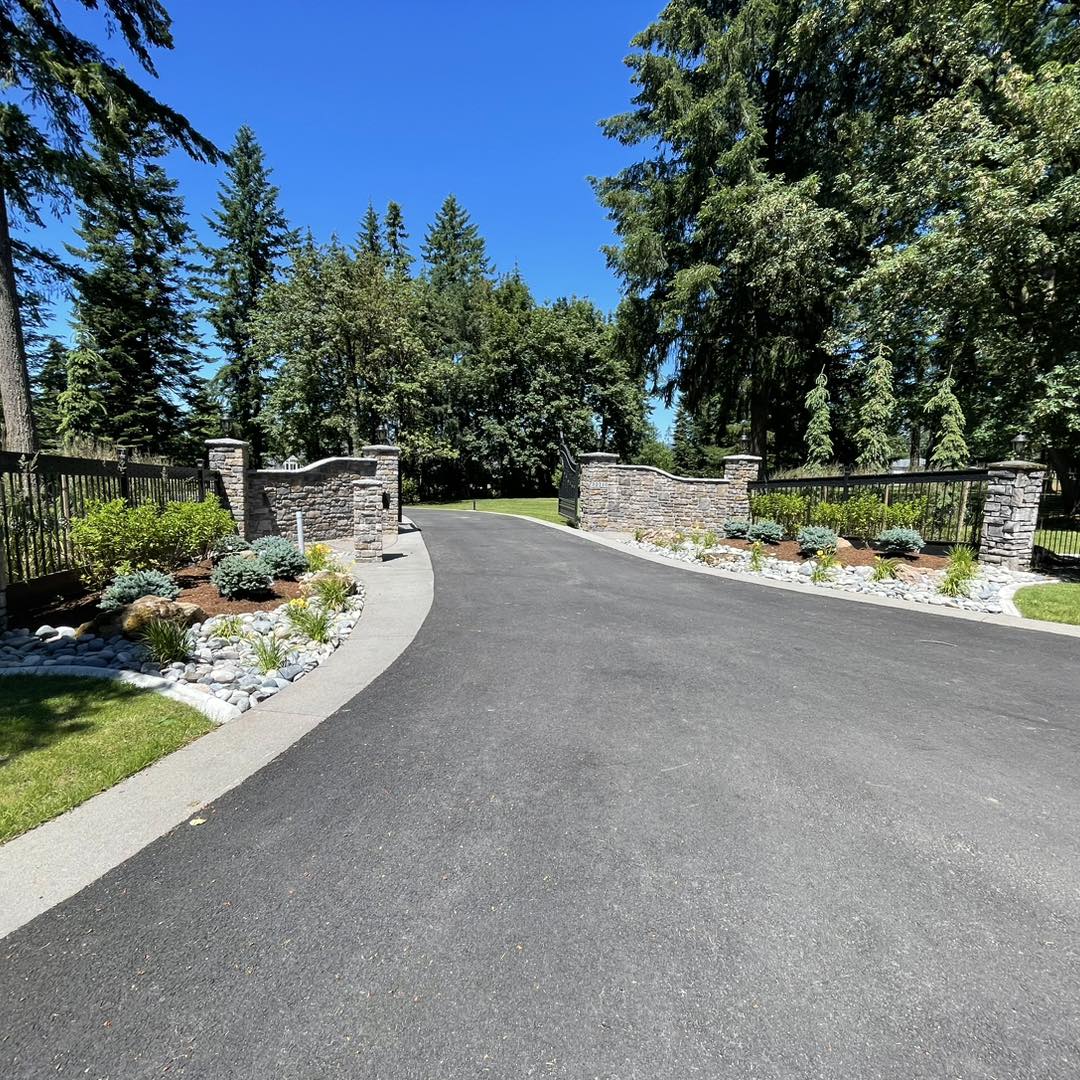 A driveway with stone and concrete accents.