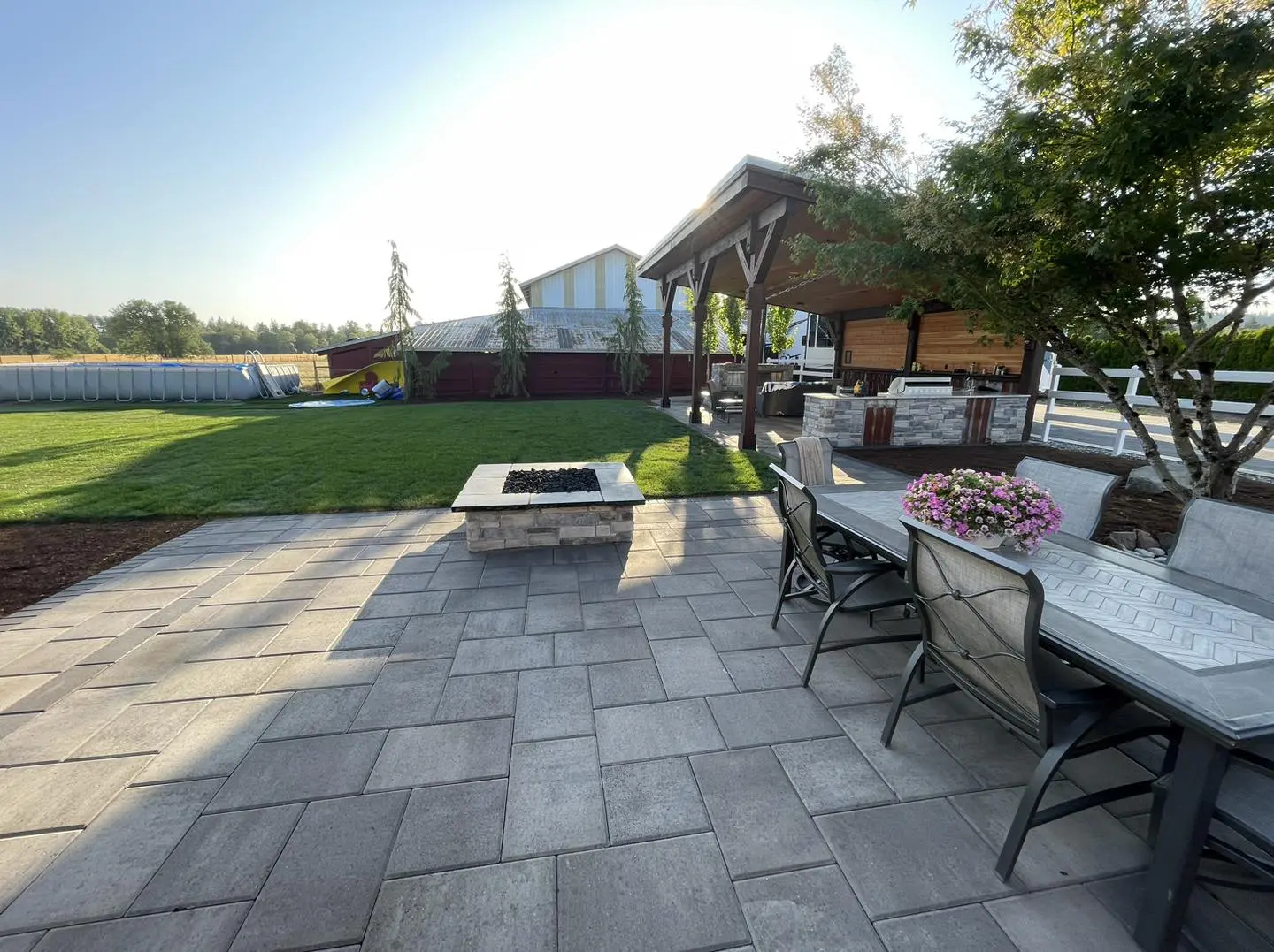 A patio with a fire pit and table in it