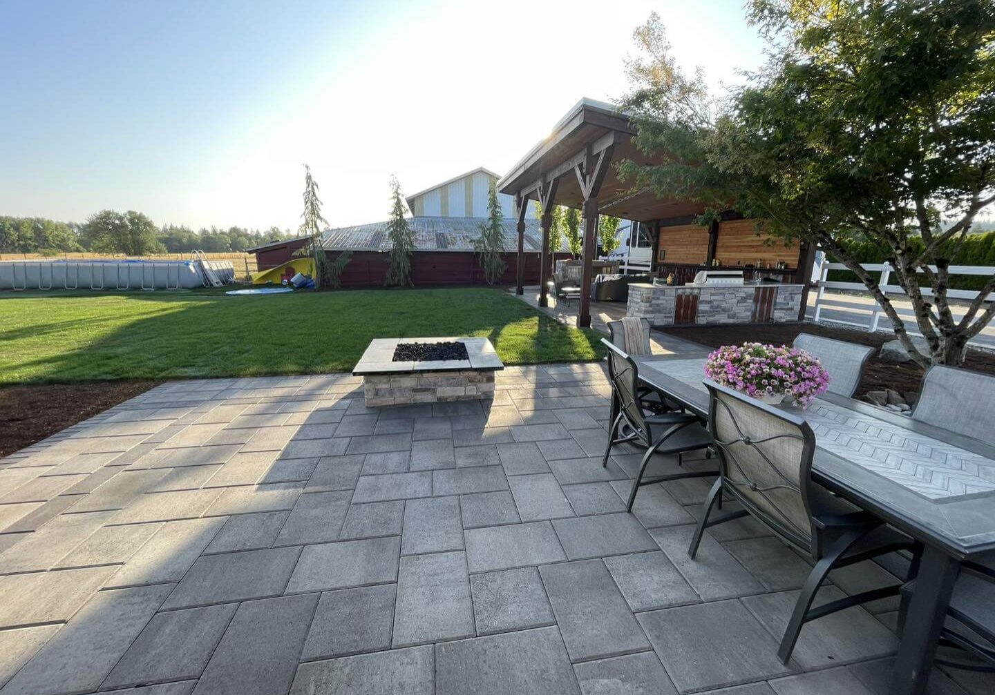 A patio with a fire pit and table in it